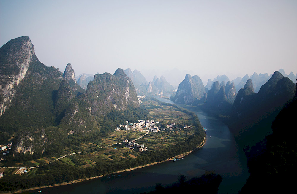 The dramatic karst formations and the serene Li River create a living watercolor painting in Guilin and Yangshuo