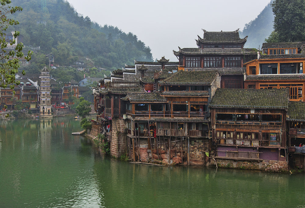 The morning mist adds a dreamlike charm to this timeless riverside village