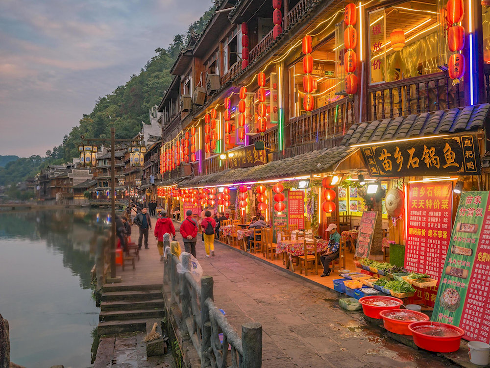 Fenghuang Ancient Town stands out with its stilt houses lining the gentle Tuojiang River 