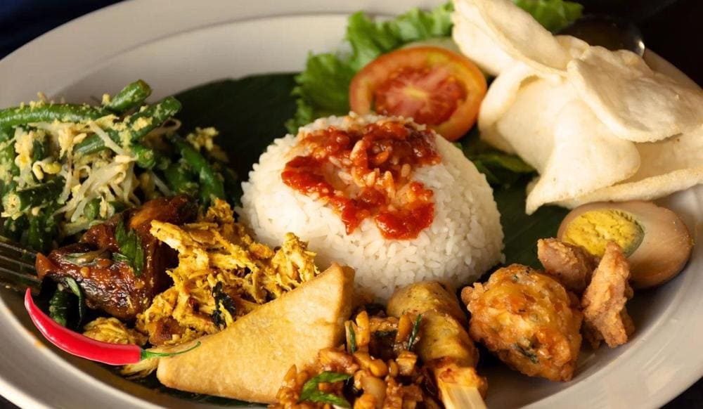 Nasi Campur is a dish that offers a unique fusion of various flavors