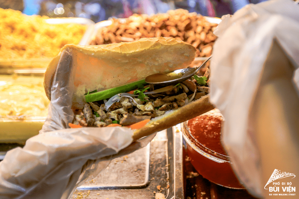 Banh mi – crispy baguette with grilled meats, pâté, eggs, and fresh veggies in every flavorful bite (Source: Fanpage Phố đi bộ Bùi Viện - Bui Vien Walking Street)