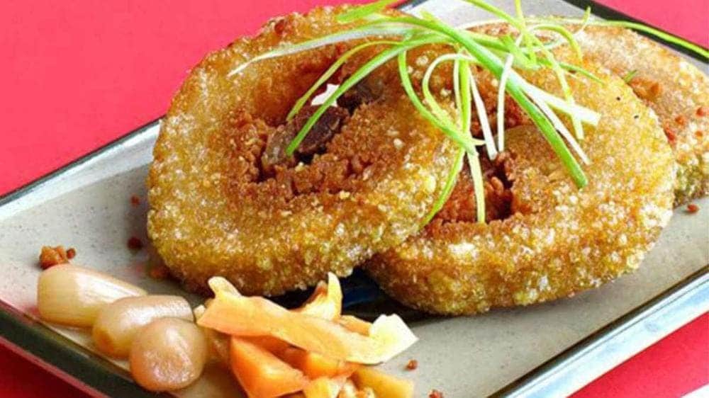 Chung cake is traditionally served with pickled vegetables and can be enjoyed fresh or pan-fried until golden brown for a crispy exterior.