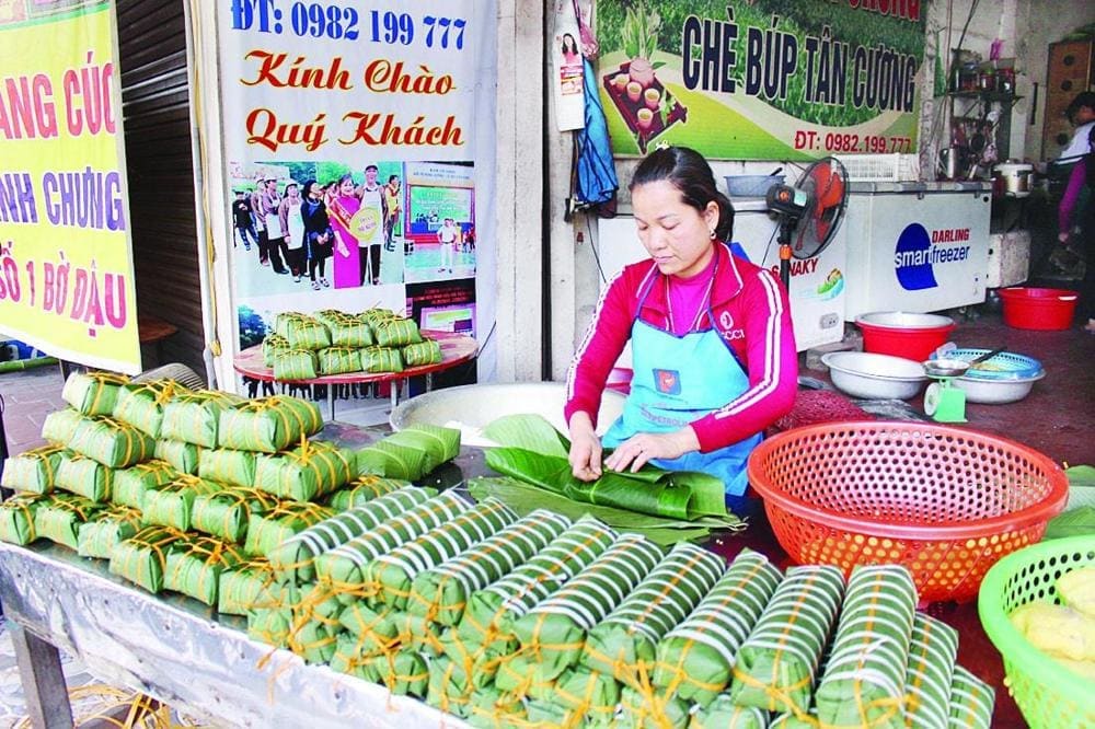 Traditional markets across Vietnam come alive during Tet season with vendors selling freshly made chung cake