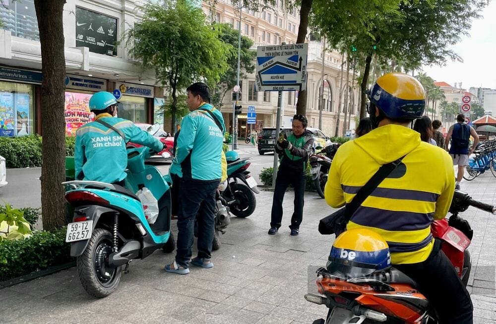 Grab, Xanh SM and Be drivers are a common sight around wet markets and food alleys