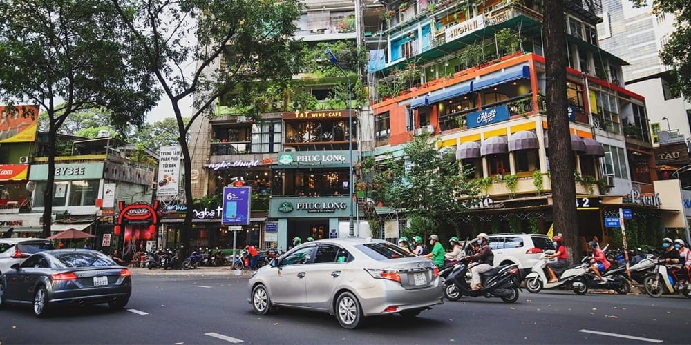 Vehicles are moving in the 3 area on a beautiful day for a delightful day
