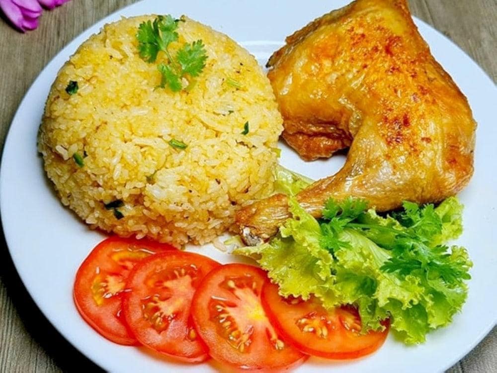 The dish is served with a side of pickled vegetables and a tasty dipping sauce