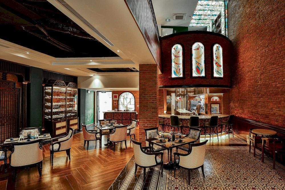 The restaurant’s Indochine-inspired décor and Gothic charm create a luxurious yet intimate setting