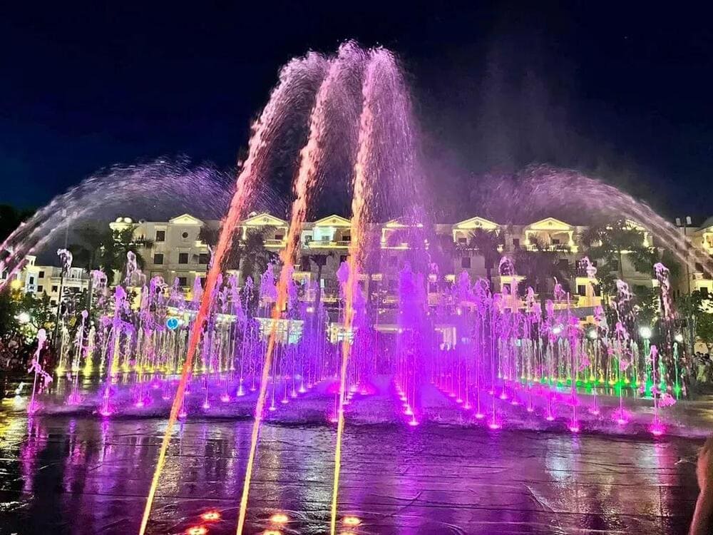 A public space featuring a water music fountain with colorful light shows
