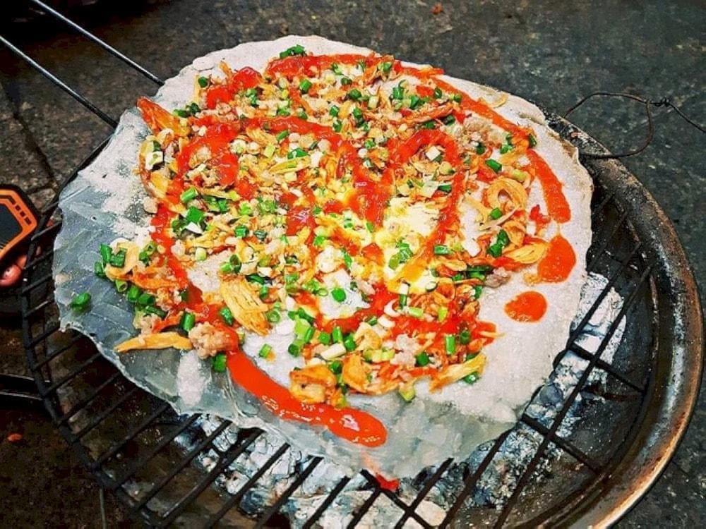 Banh Trang Nuong (Grilled Rice Paper) is a popular street food at Nguyen Hue Walking Street