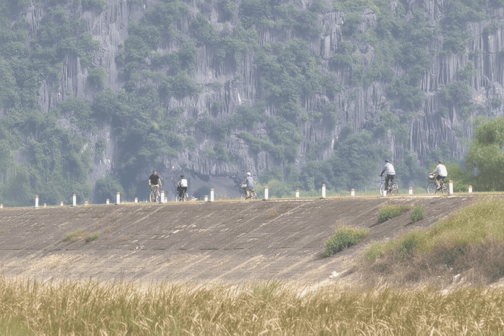 Cycling through villages and along the dikes is a wonderful way to experience the tranquil rhythm of Northern Vietnam