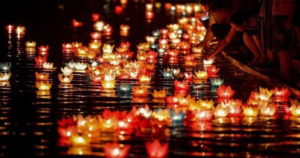 Floodwaters reflect glowing lanterns in the ancient town of Hoi An during a seasonal downpour