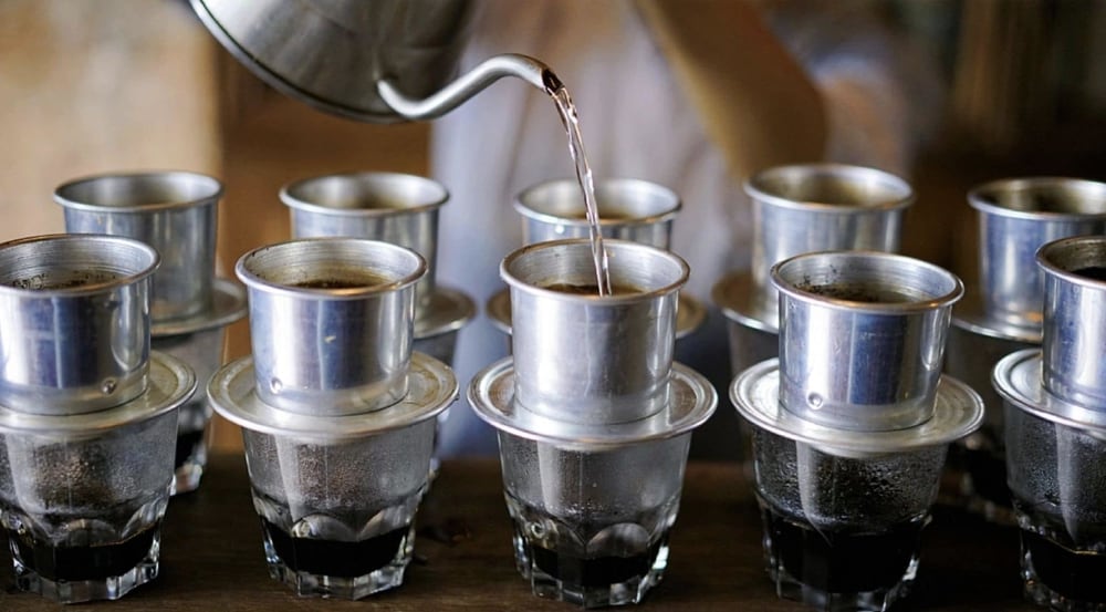 Colorful array of different Vietnamese coffee variations served in traditional glasses.