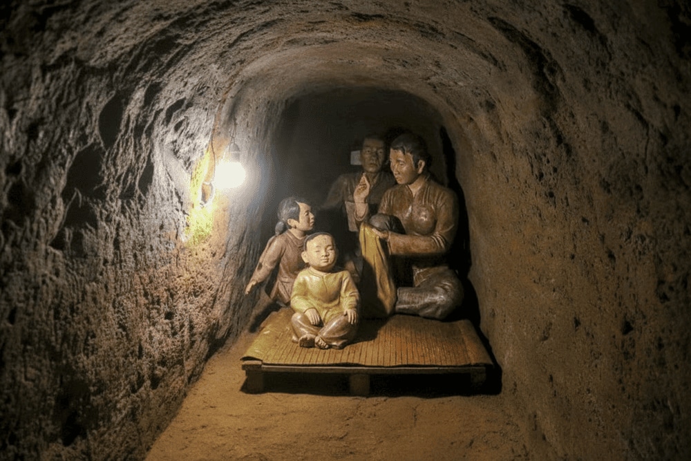 Exhibits include hand tools, personal belongings, and models of the tunnel system