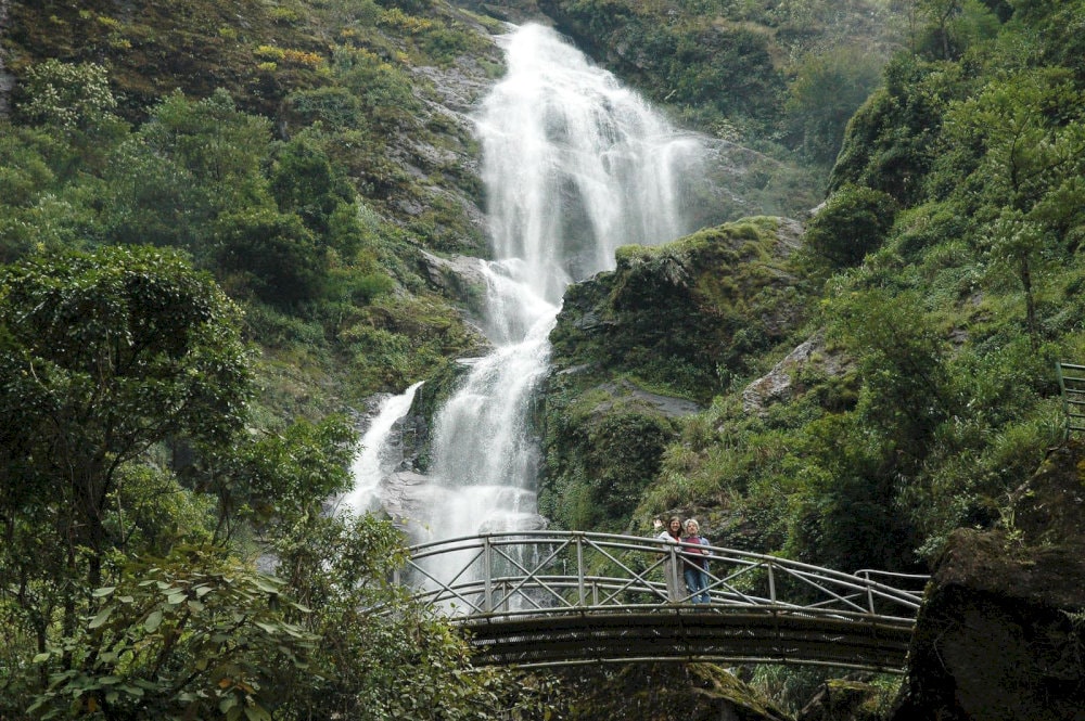Silver Waterfall in Sapa cascades dramatically through layers of dense forest