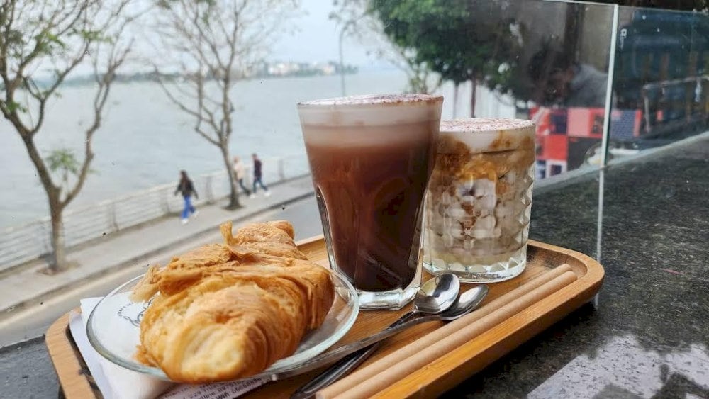 Enjoy your favorite beverage with the calming embrace of West Lake's morning serenity