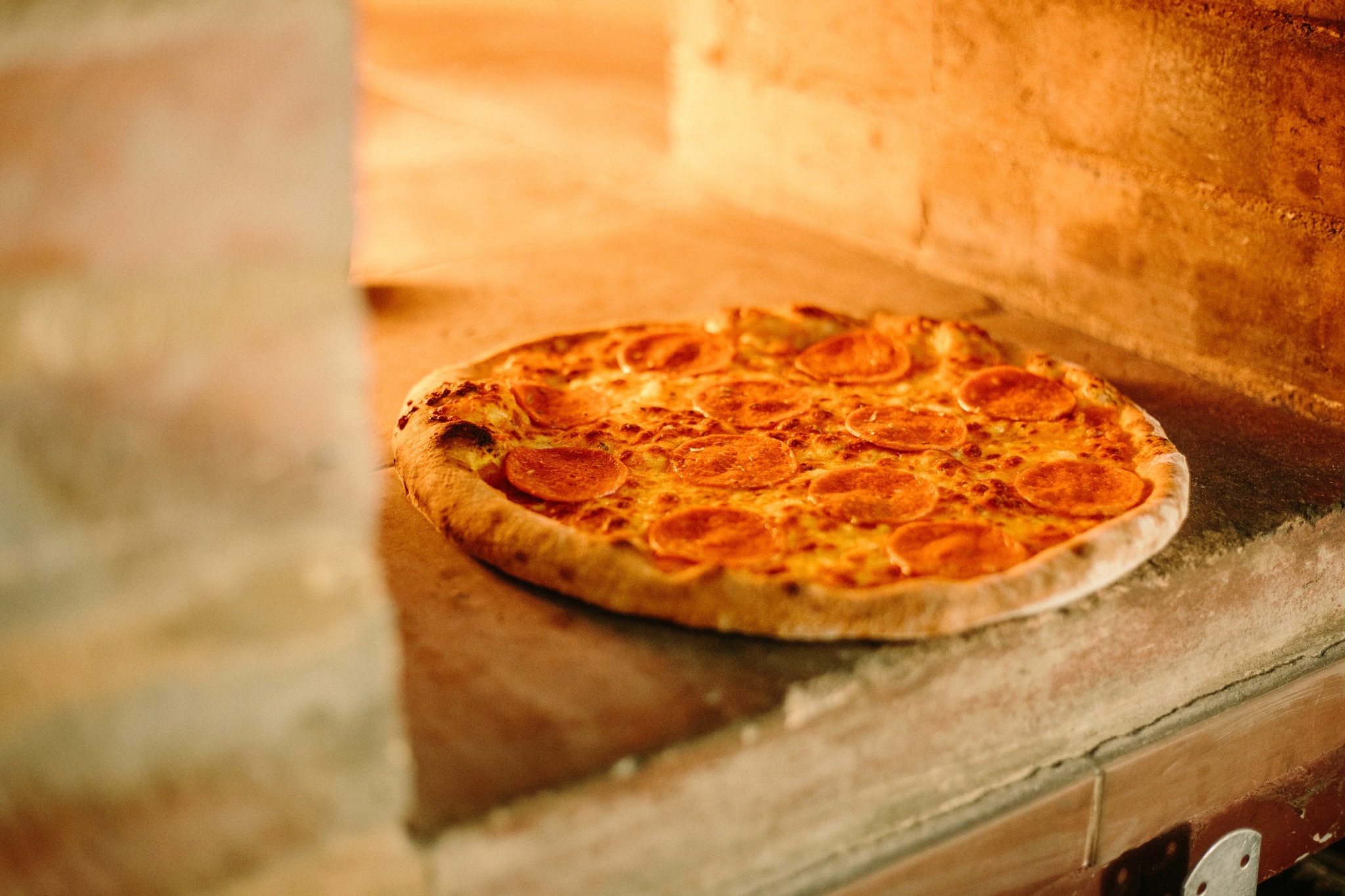 Guests can watch their pizzas prepared in a traditional oven placed right behind the counter