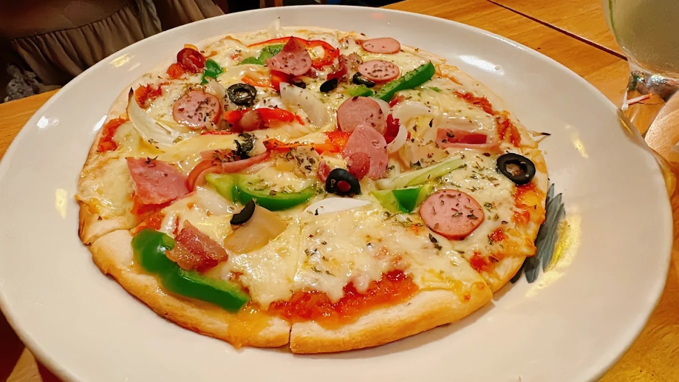 Many guests return for the balanced flavors and satisfying texture of the Italian-style pizzas