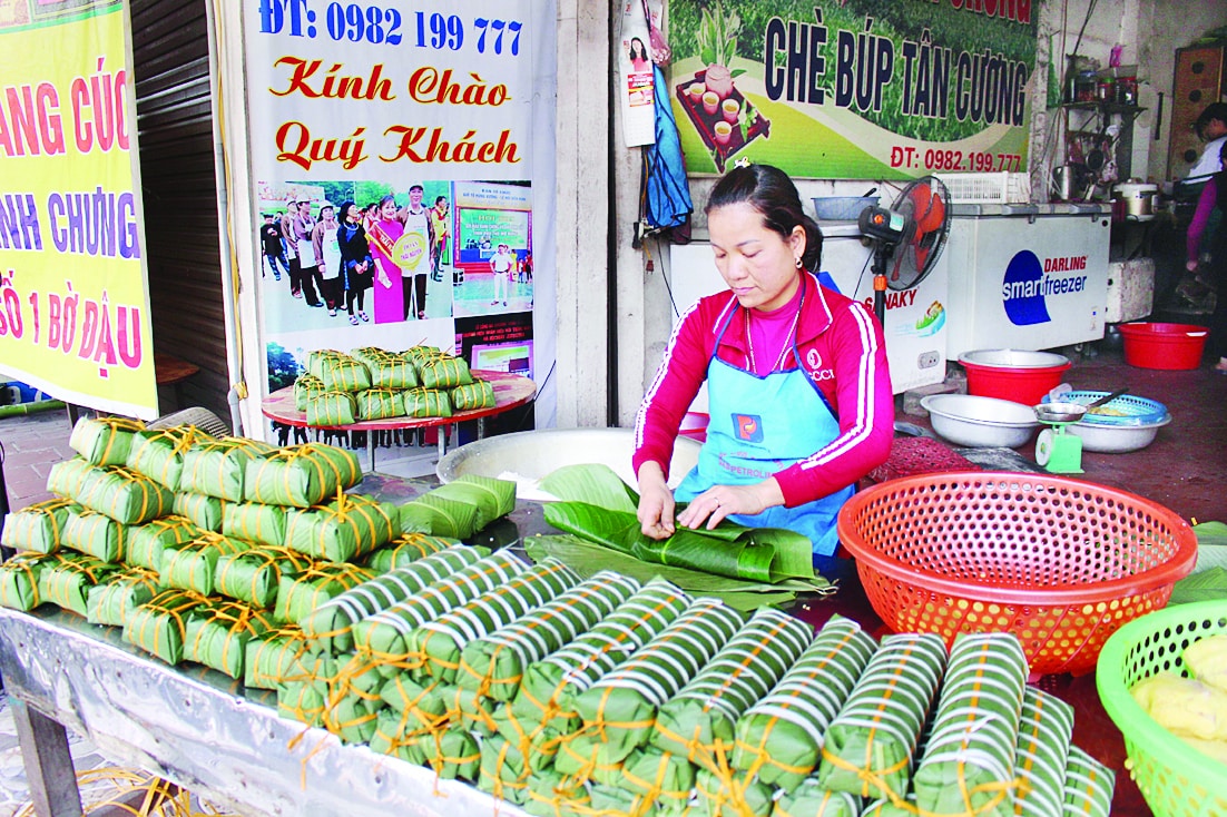 Traditional markets across Vietnam come alive during Tet season with vendors selling freshly made chung cake