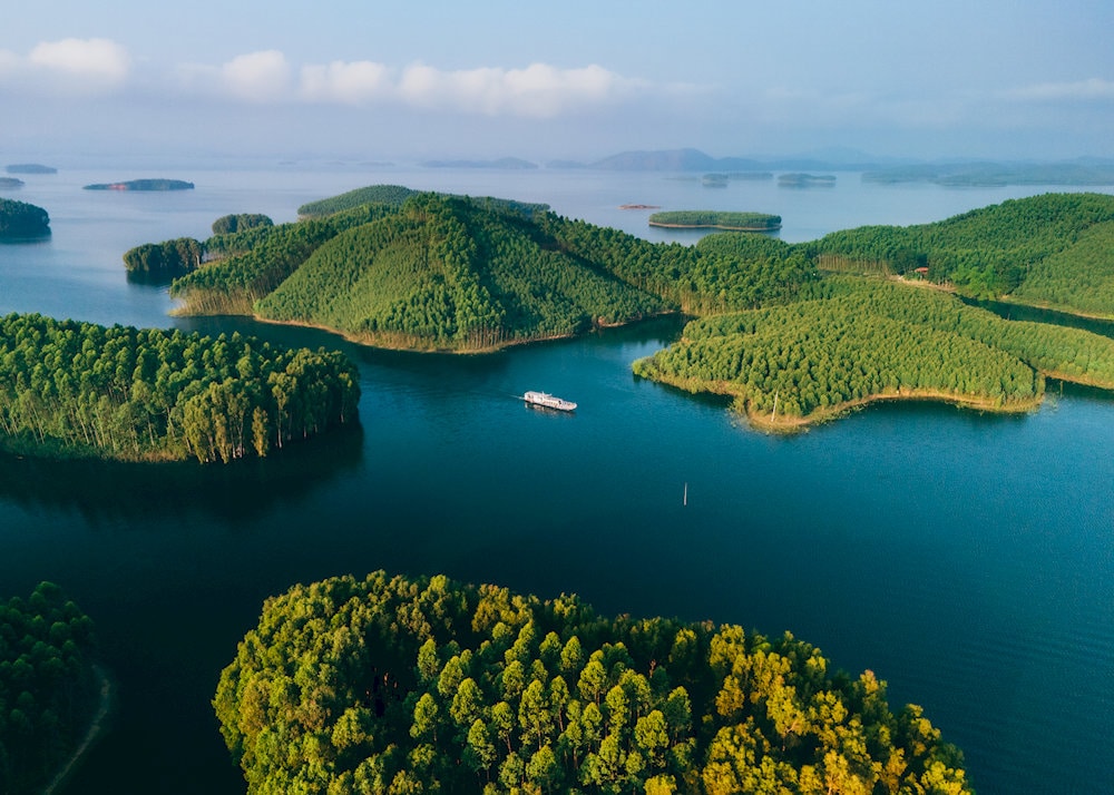 A tranquil island rises from the misty waters of Thac Ba Lake