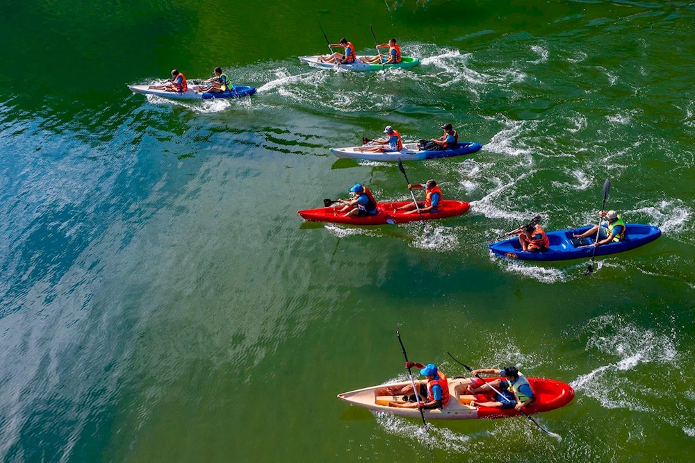 Kayakers glide peacefully through the still waters, surrounded by greenery