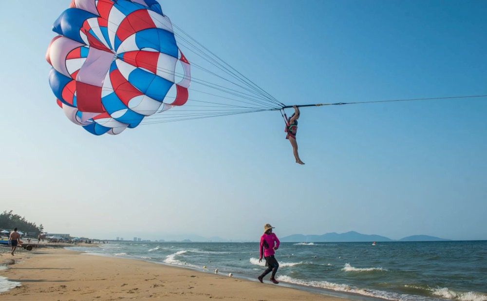 Parasailing offers you a sense of adventure, allowing you to see the crystal clear water and white sand 