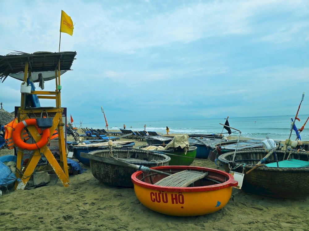 The serene beauty of An Bang Beach in Vietnam, featuring traditional round fishing boats.