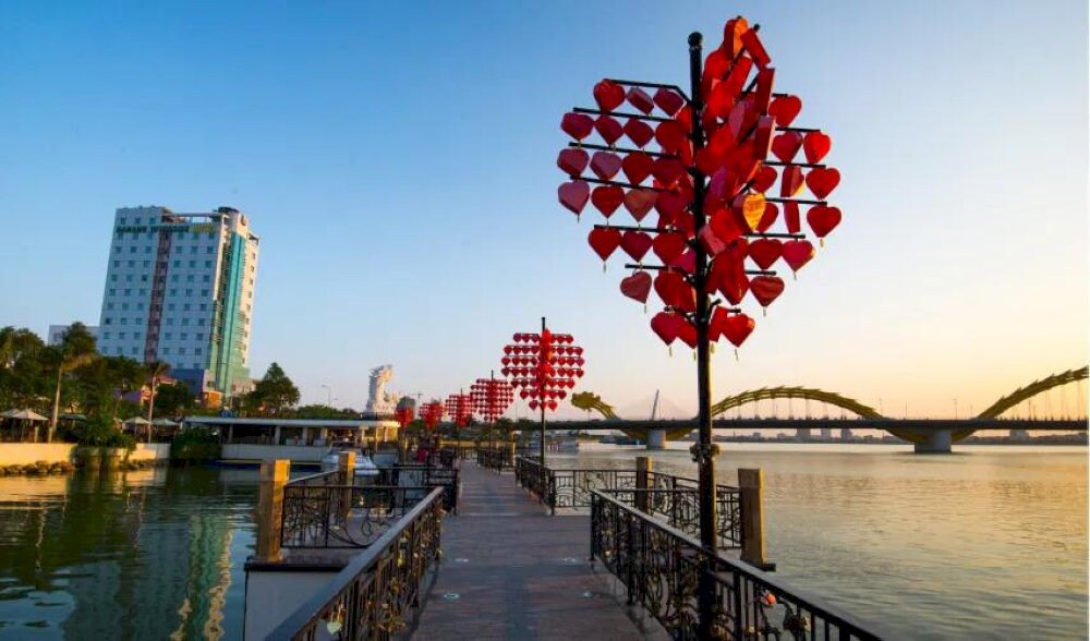 Love Bridge in Da Nang is a romantic riverside spot adorned with heart-shaped lanterns, perfect for couples to date