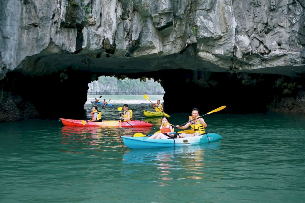 Embark on a kayaking journey along Chay River, a serene prelude to the cave adventure