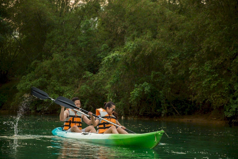 Engage in eco-friendly leisure activities such as paddle boarding or kayaking in a quiet natural space
