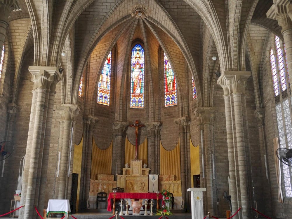 The cathedral's interior is bathed in multicolored light filtered through the stained glass
