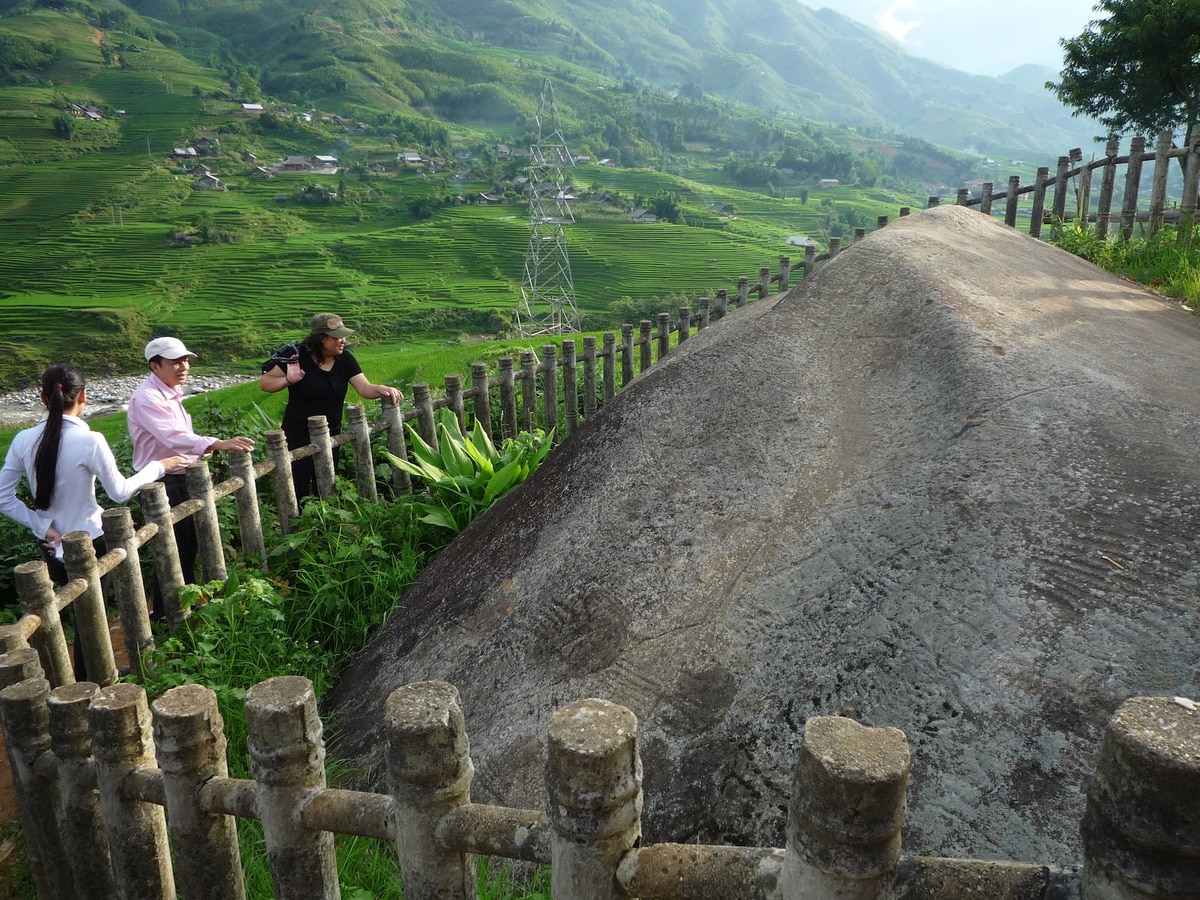 The Sapa Ancient Rock Field features hundreds of centuries-old carved stones scattered across rice terraces