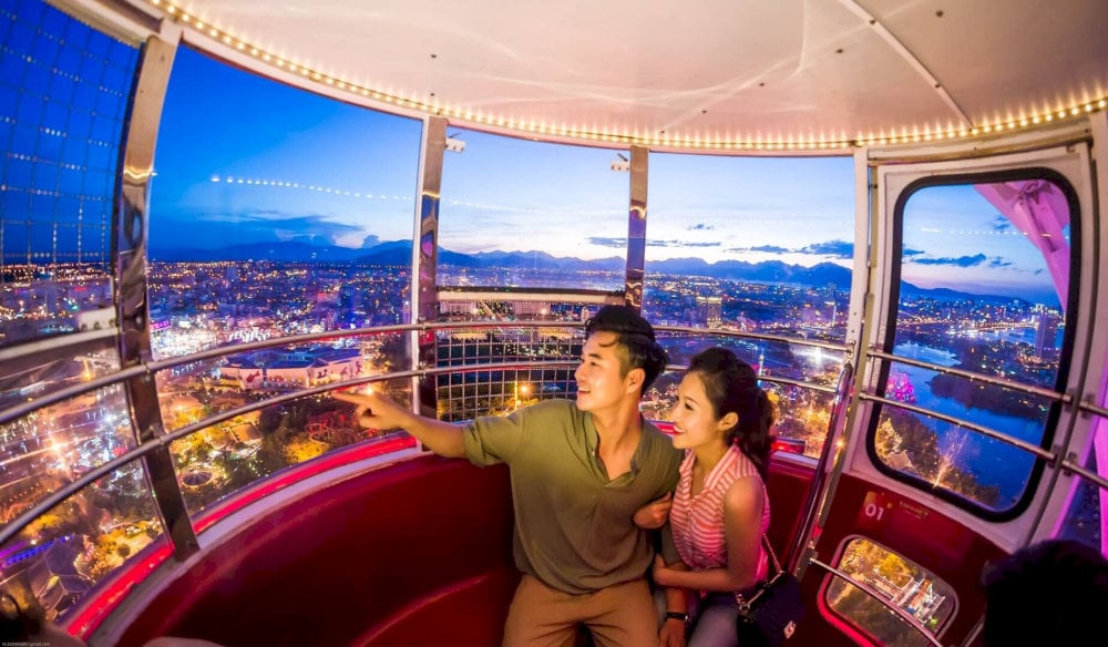 The view becomes magical with the city illuminated by countless lights, creating a dazzling, sparkling night scene