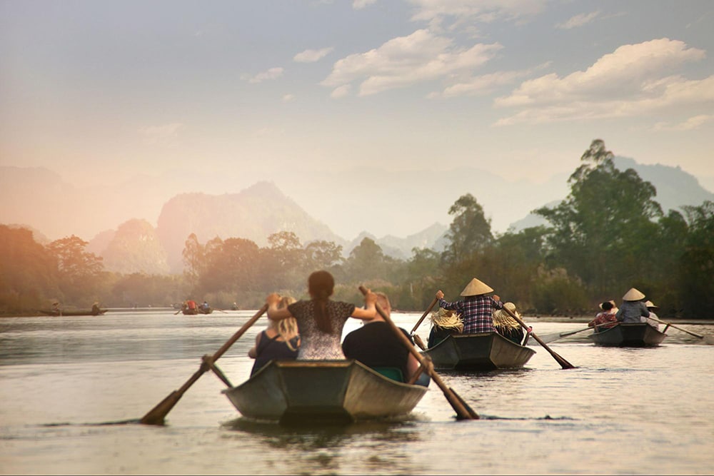 Taking a boat riding along the river is an exciting experience when going to Huong Pagoda 
