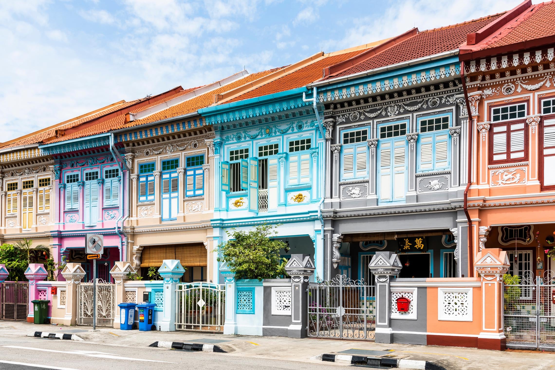 Rows of colorful Peranakan shophouses with distinctive architecture, deeply rooted in Singapore’s cultural heritage