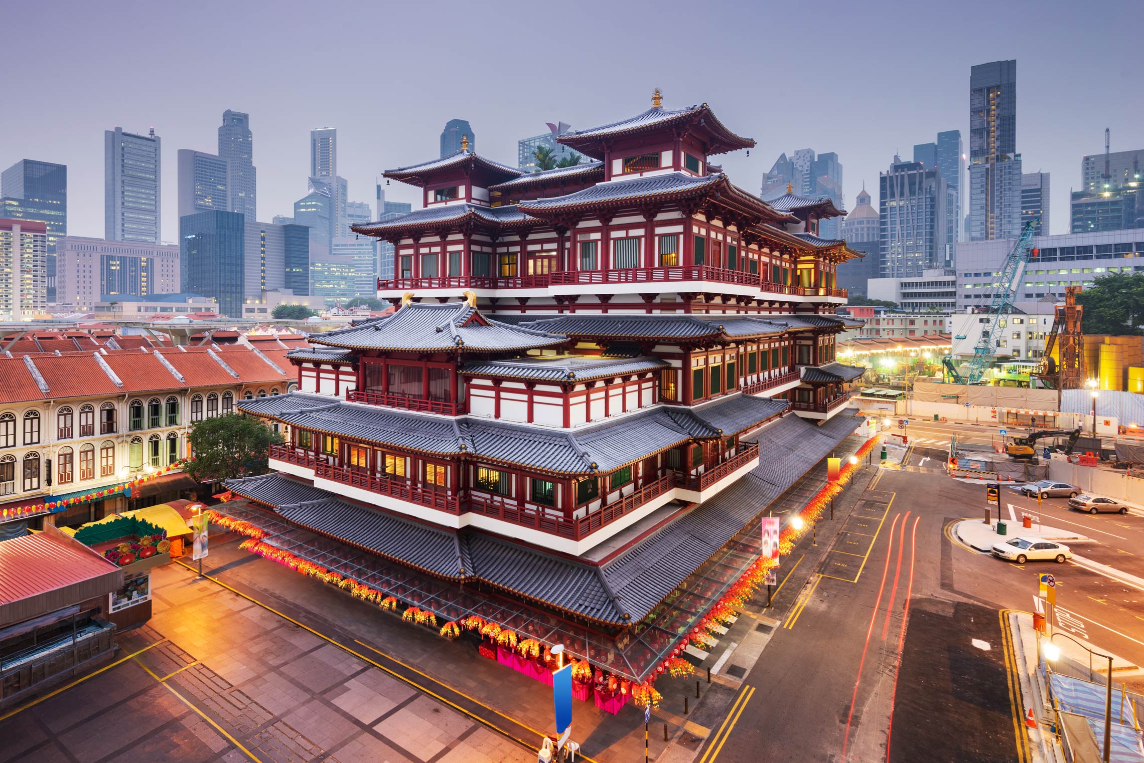 Buddha Tooth Relic Temple and Singapore skyline at twilight in Chinatown, a cultural highlight among things to do in Singapore