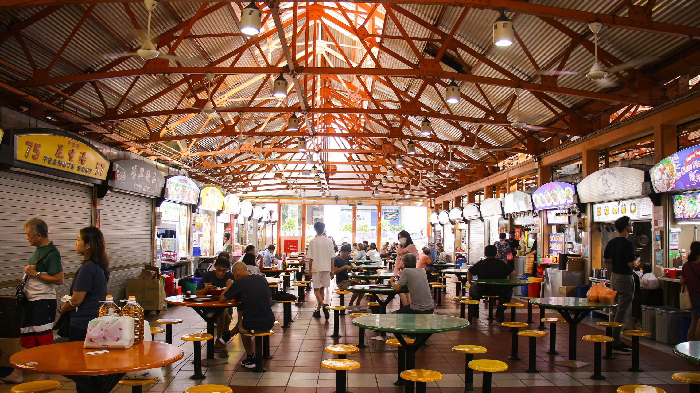 Tourists can try many Singaporean dishes at the lively food court at Maxwell Food Centre in Singapore
