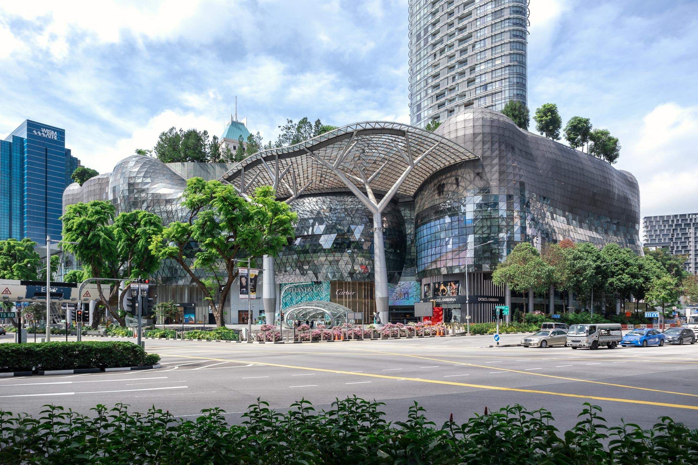 Interior of a modern shopping mall in Singapore with retail stores, shoppers, and a variety of souvenirs from Singapore