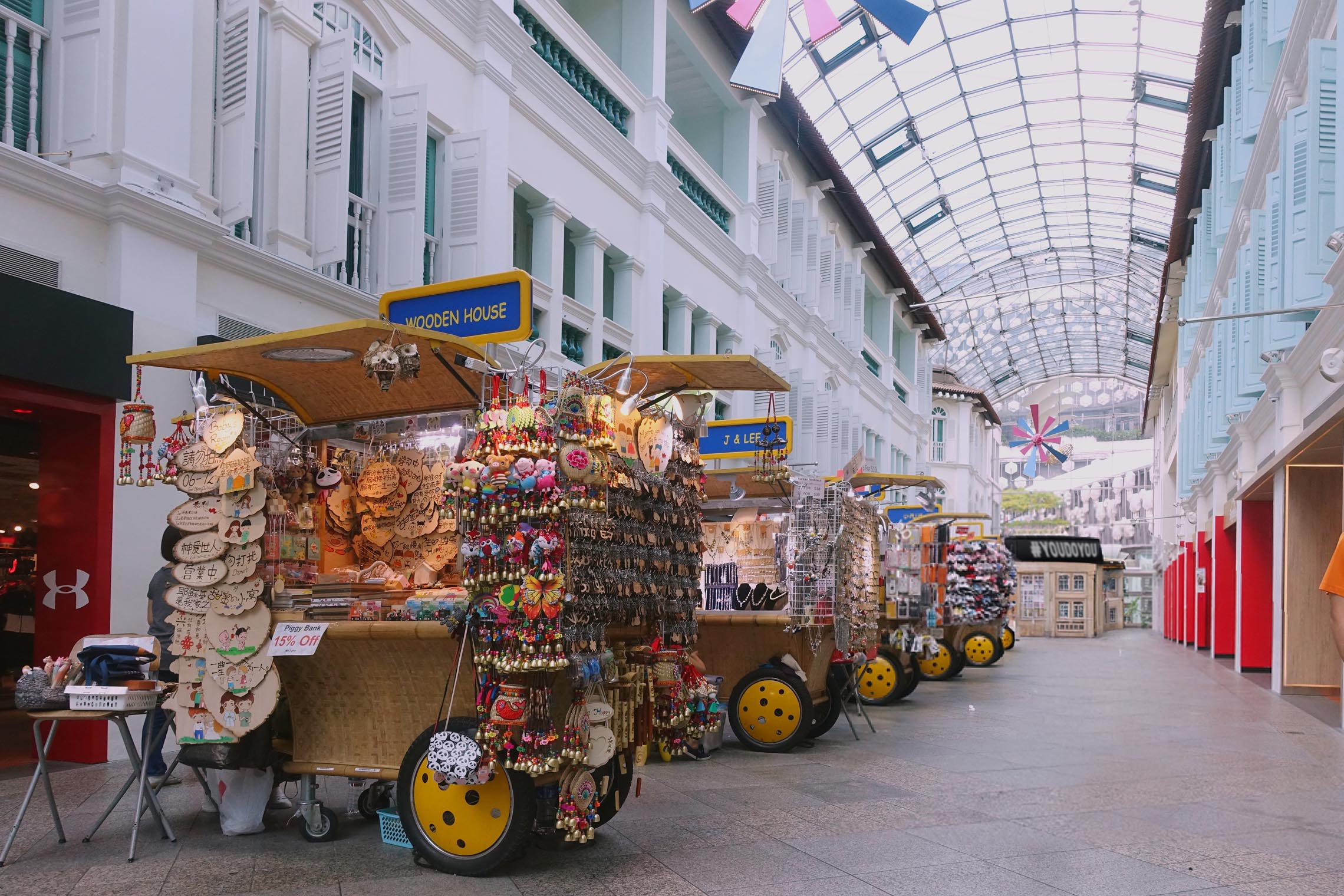 Tourists exploring and shopping along Bugis Street in Singapore, a lively destination for finding a souvenir from Singapore