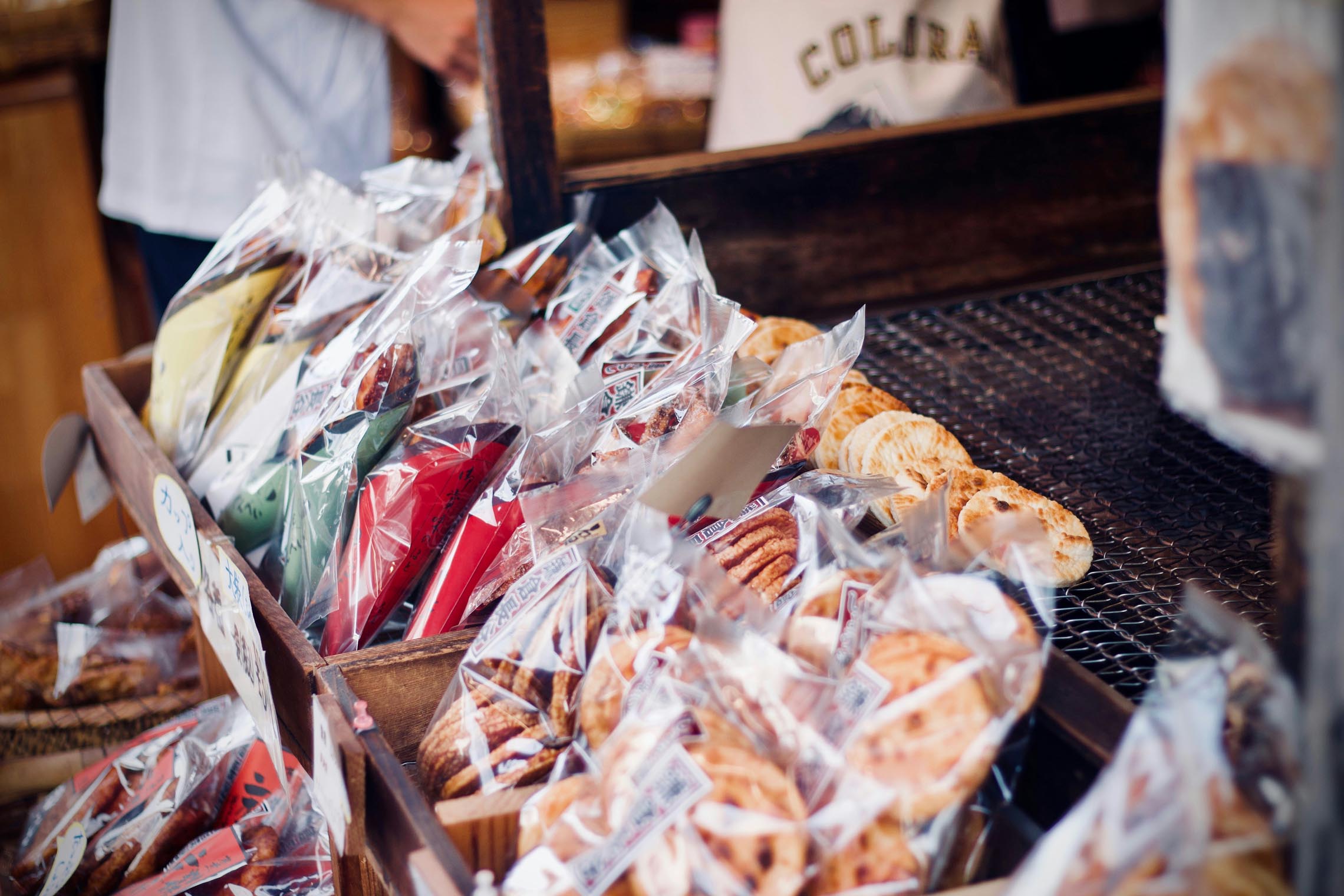 Japanese senbei and seasonal sweets displayed at a Tokyo shopping district counter