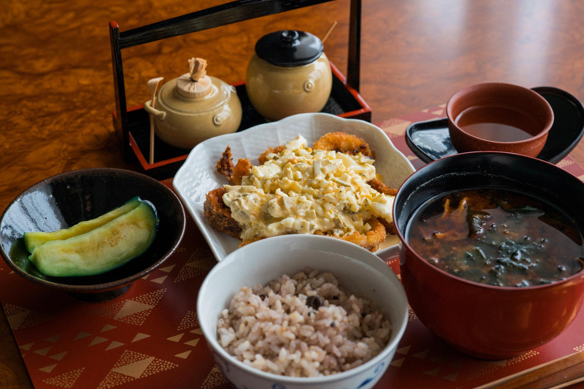 Tokyo hotels serving a Japanese breakfast with steamed rice, grilled salmon, tuna, miso soup, tamagoyaki, and traditional side dishes