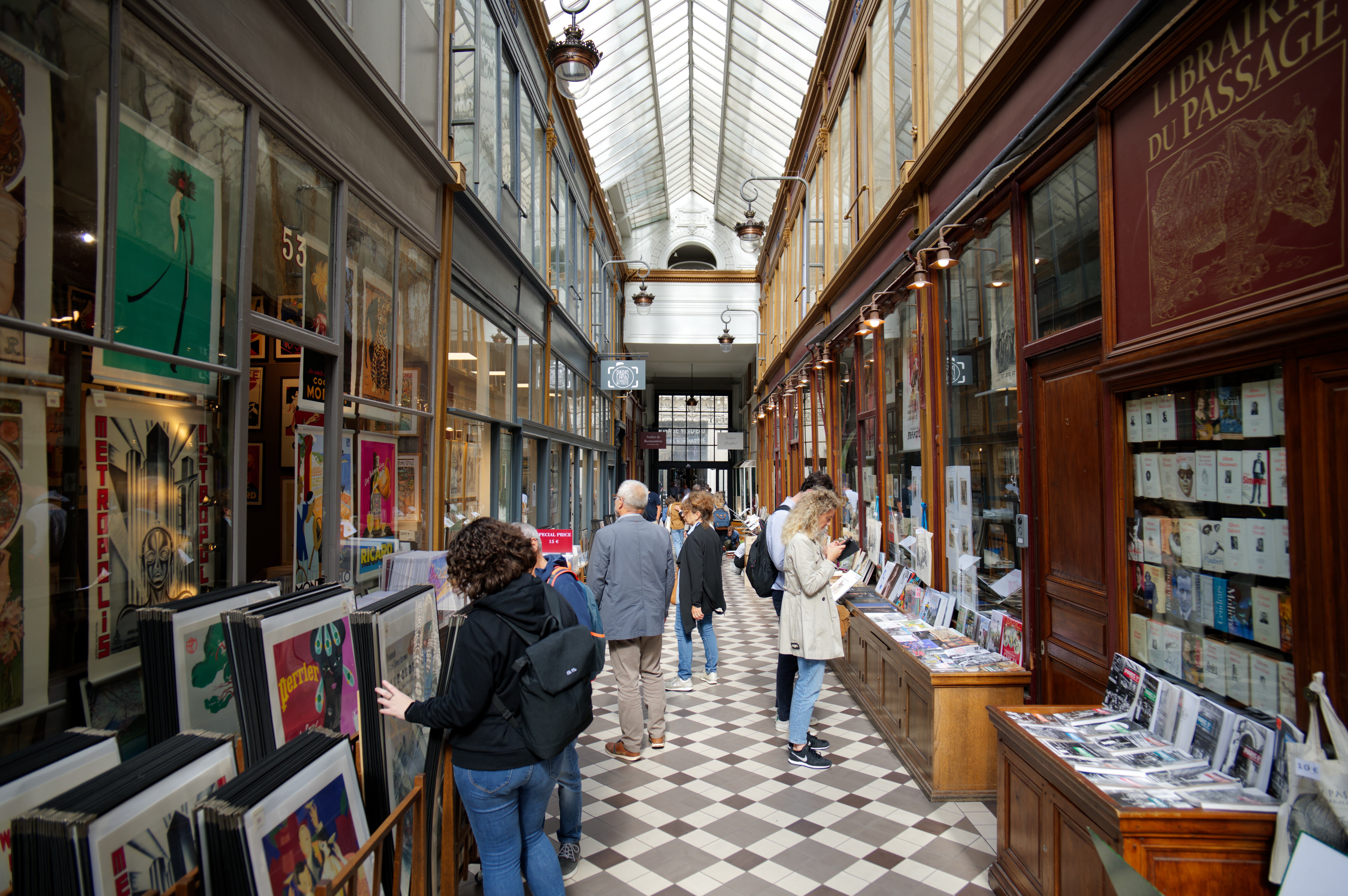 Tourists browsing artworks and books at a shopping destination in France