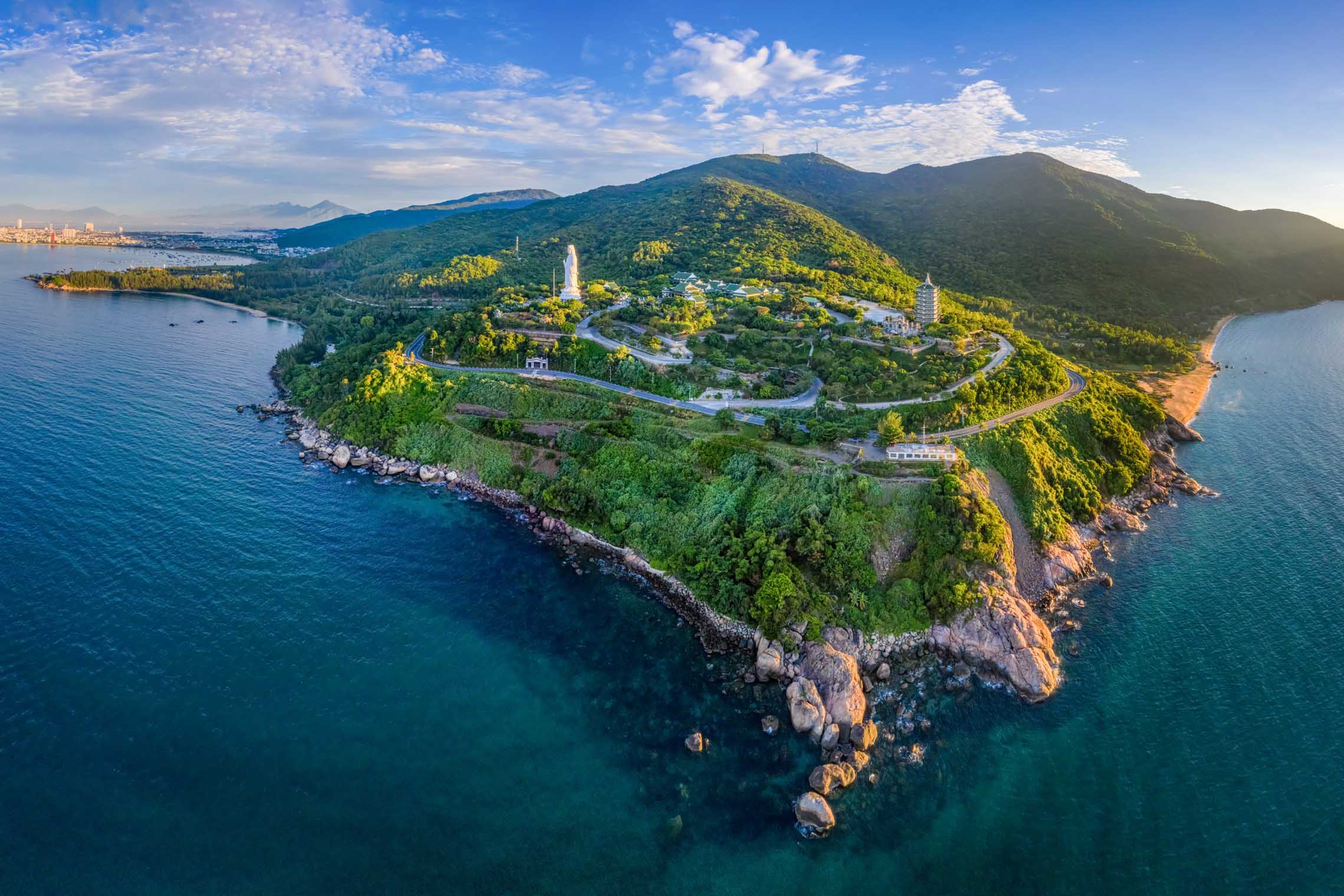 Linh Ung Pagoda viewed from above, surrounded by mountains and the sea, one of the iconic Da Nang attractions in Danang, Vietnam