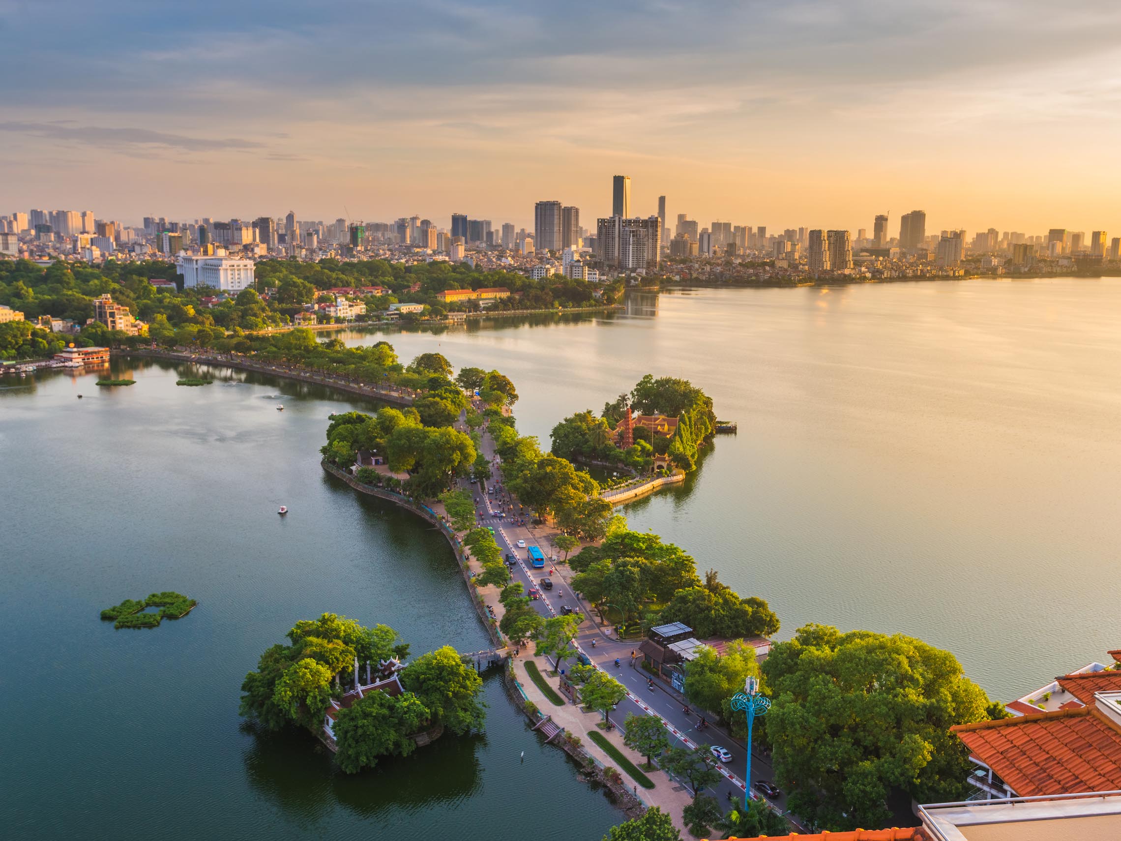 Morning view of Hoan Kiem Lake in Ha Noi, surrounded by trees and historic landmarks