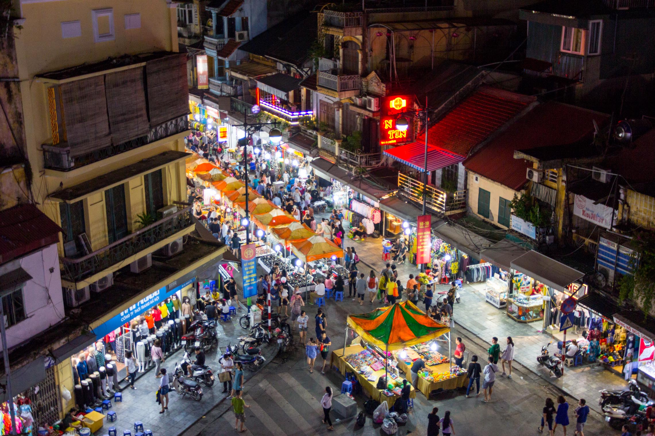 Hanoi night market in the Old Quarter with stalls selling local specialties and traditional souvenirs