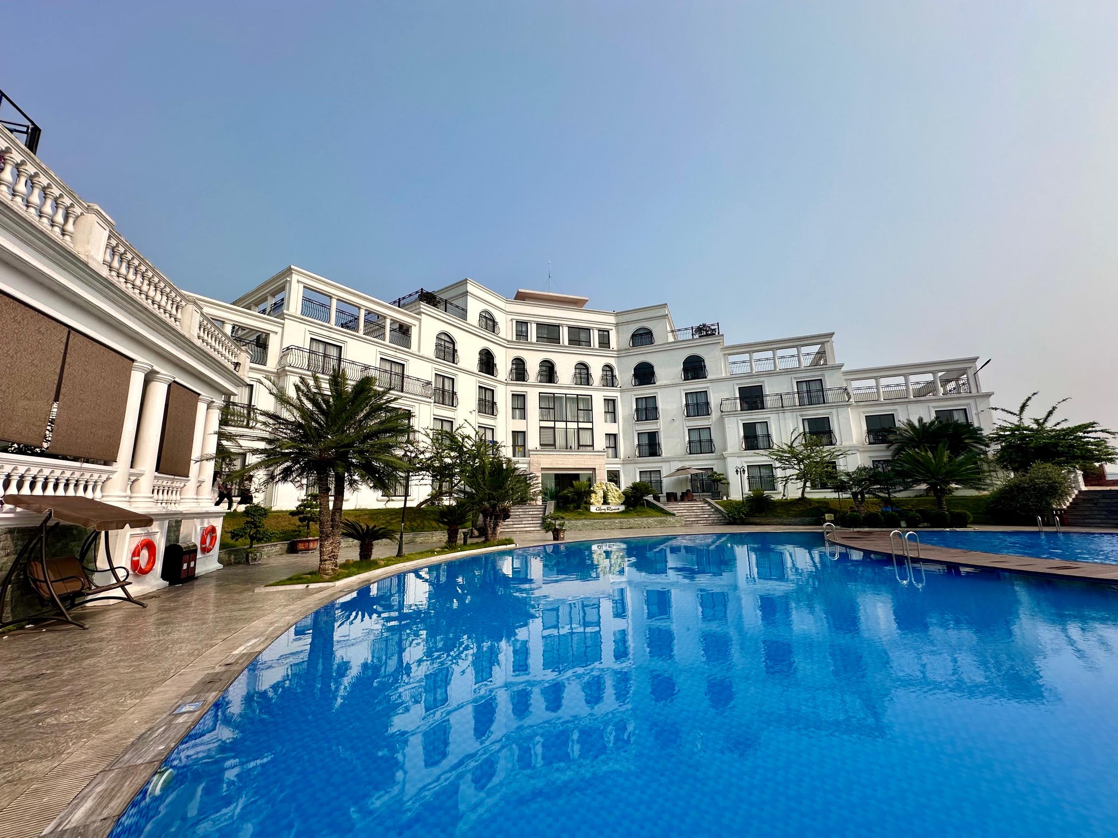 Hanoi hotel with an outdoor swimming pool surrounded by modern architecture
