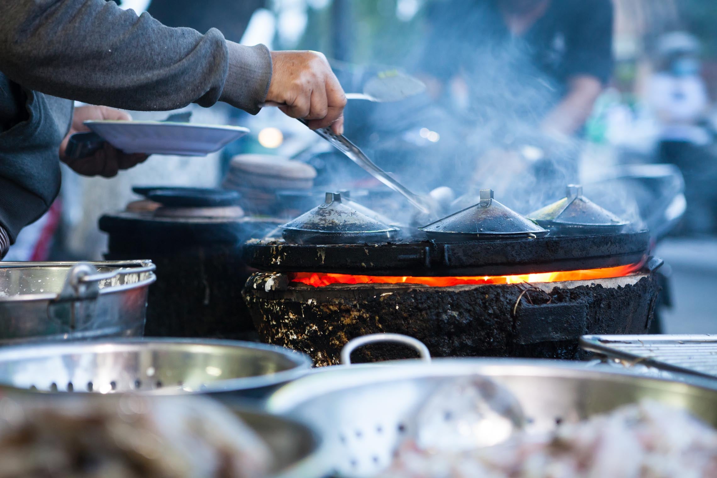 Cooking scene at a Nha Trang restaurant featuring fresh ingredients and traditional flavors.