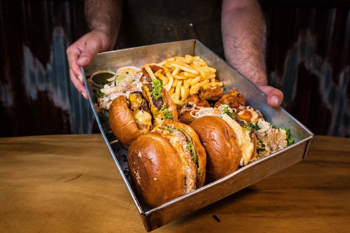 "Burger at Mischief & Mayhem with succulent beef, cheese, bacon, and special sauce