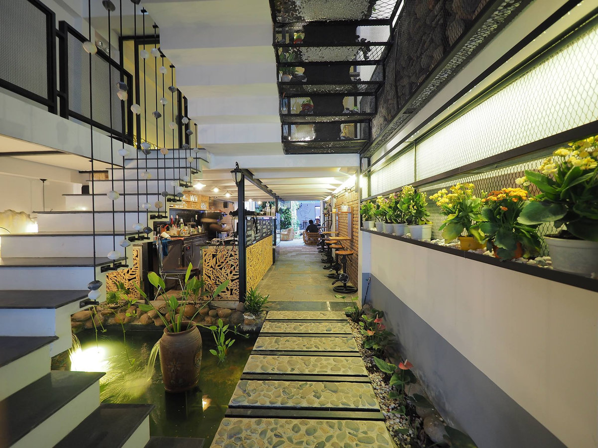 The space in Ribo is decorated like a house in a garden, with trees and flowers 