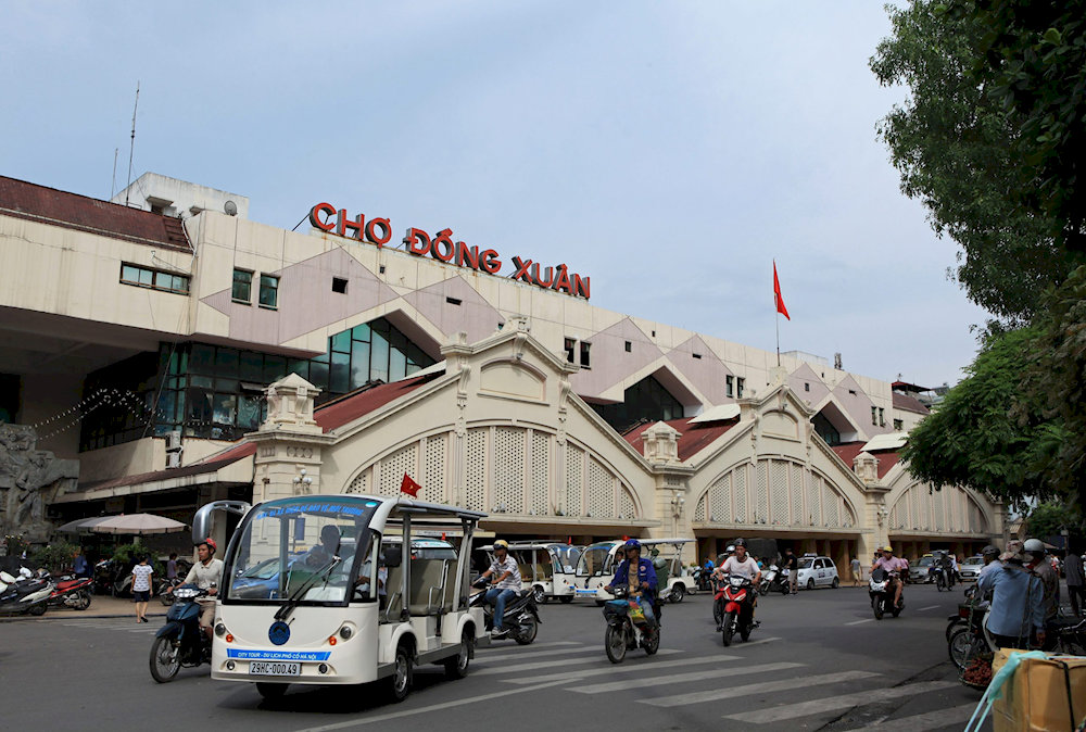 Dong Xuan Market bustles with stalls selling clothes, food, and souvenirs in Hanoi’s largest indoor market