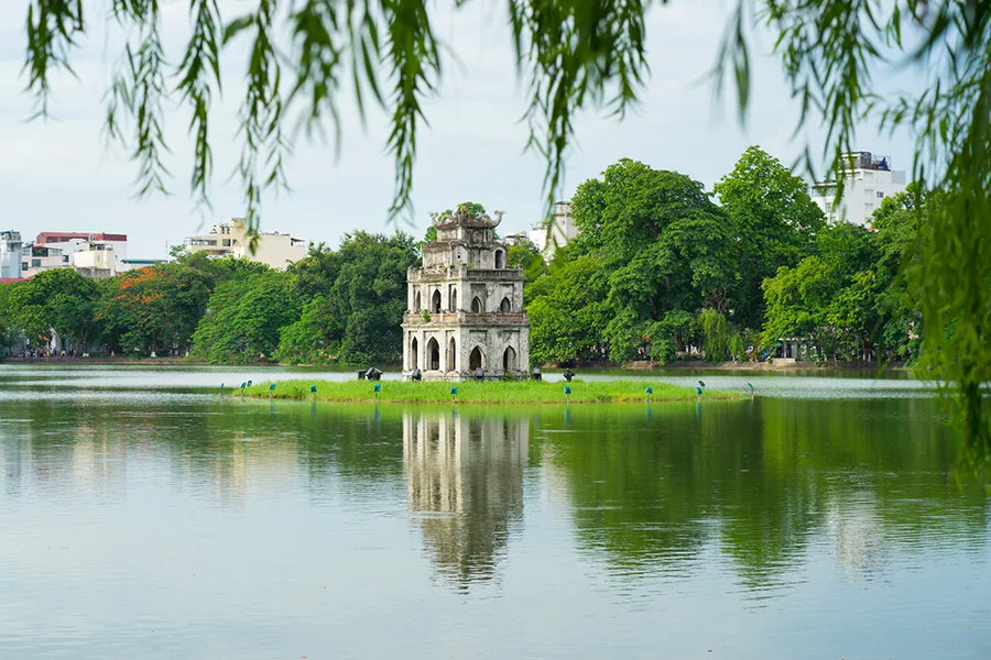 Discover the charm of Vietnam with a visit to the picturesque Hoan Kiem Lake, where the iconic Turtle Tower creates a stunning landscape